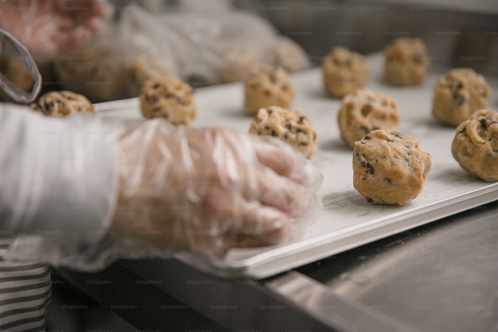 a person holding a tray of cookies in their hands
