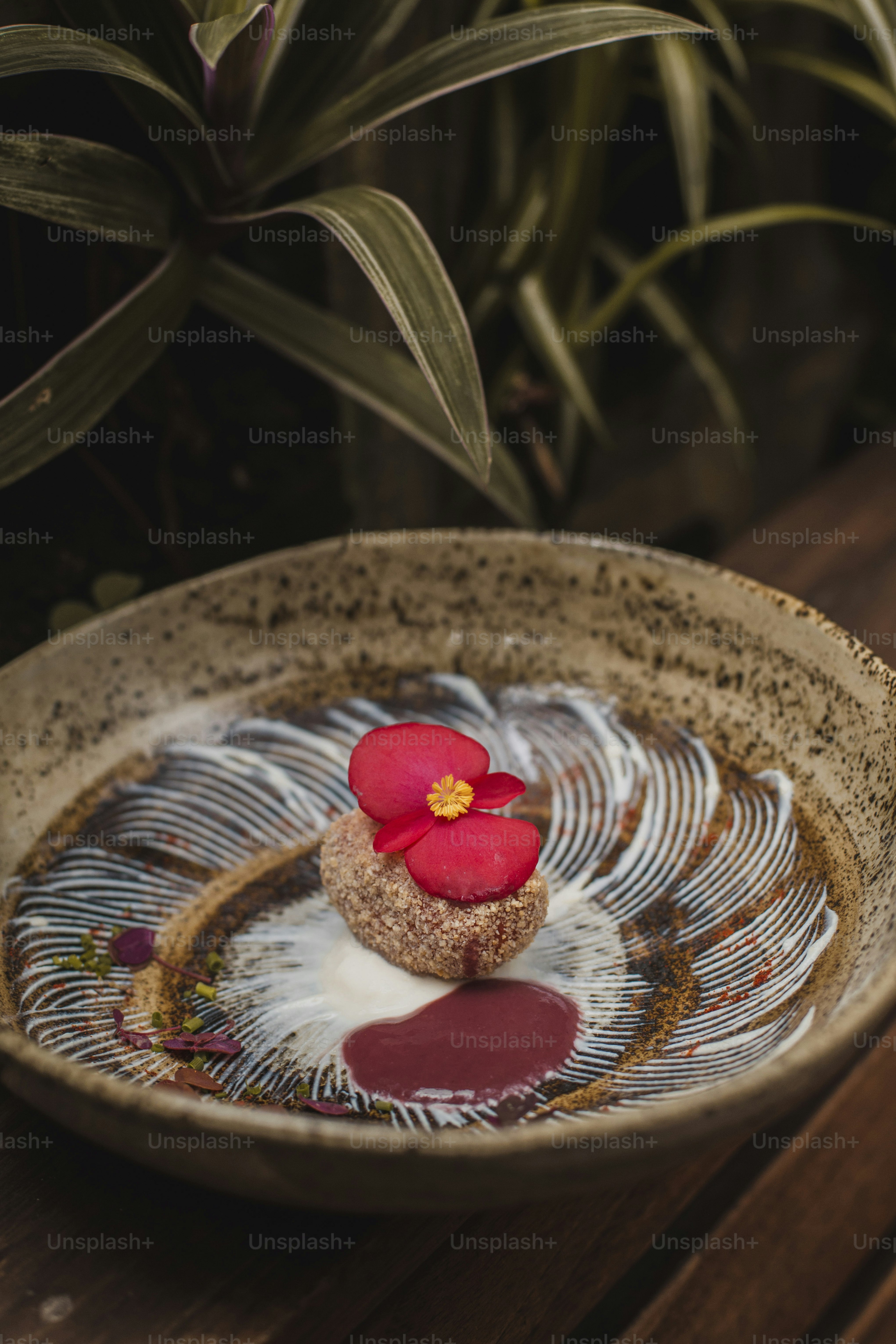 a plate with a flower on it on a table