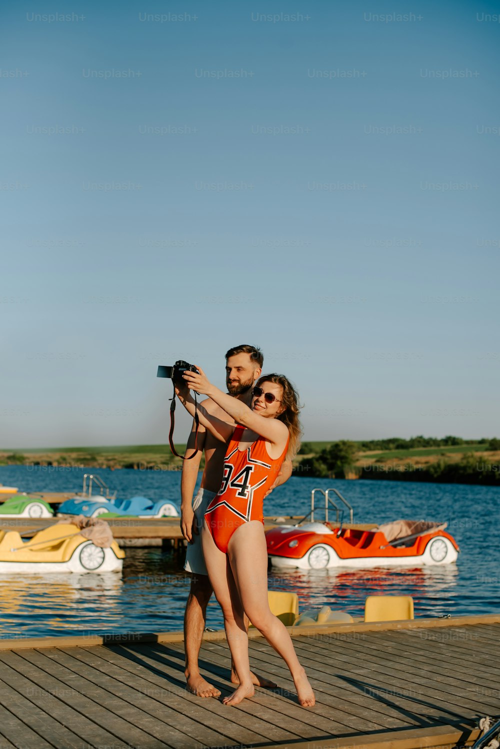 a man taking a picture of a woman in a bathing suit