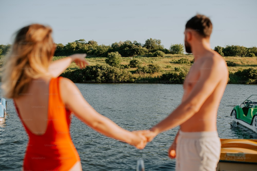 a man and a woman holding hands on a boat