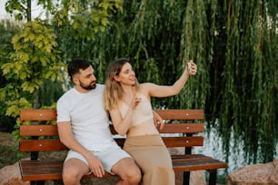 a man and a woman are sitting on a bench