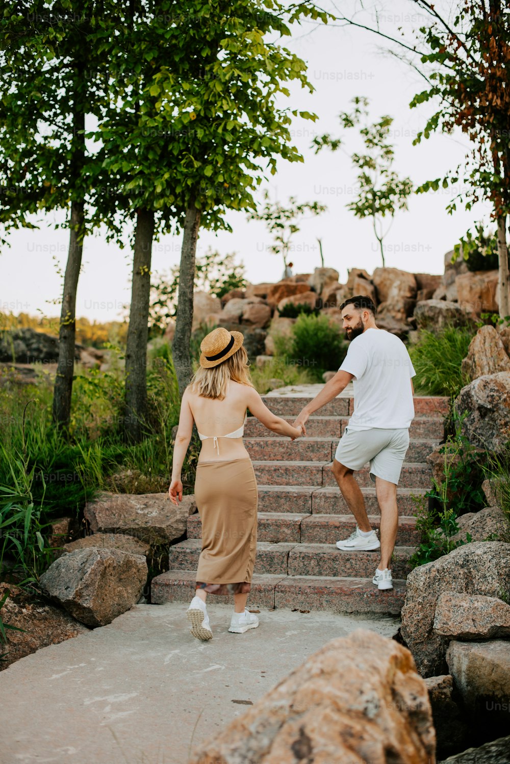 a man and a woman walking up some steps