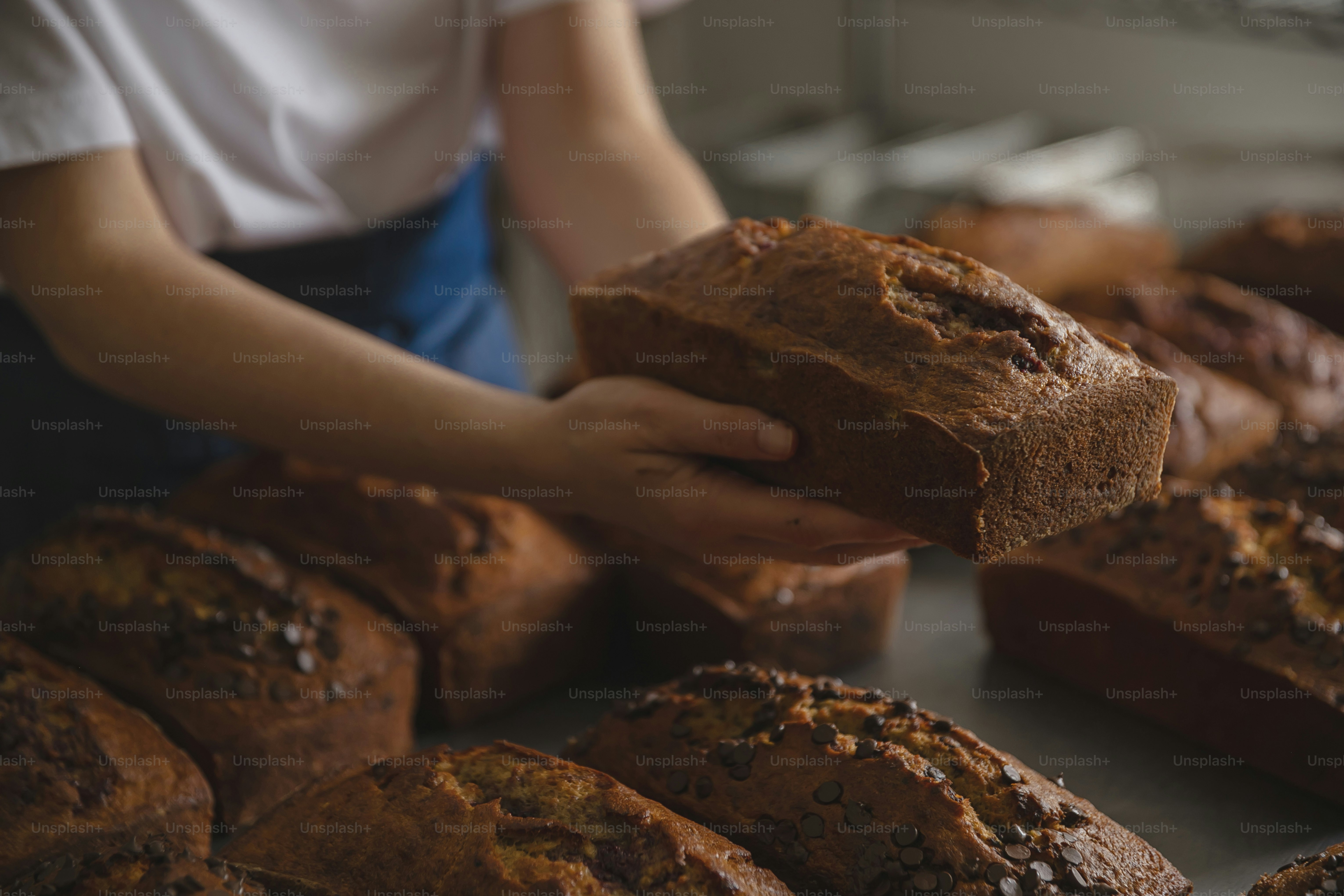 a woman is holding a loaf of bread