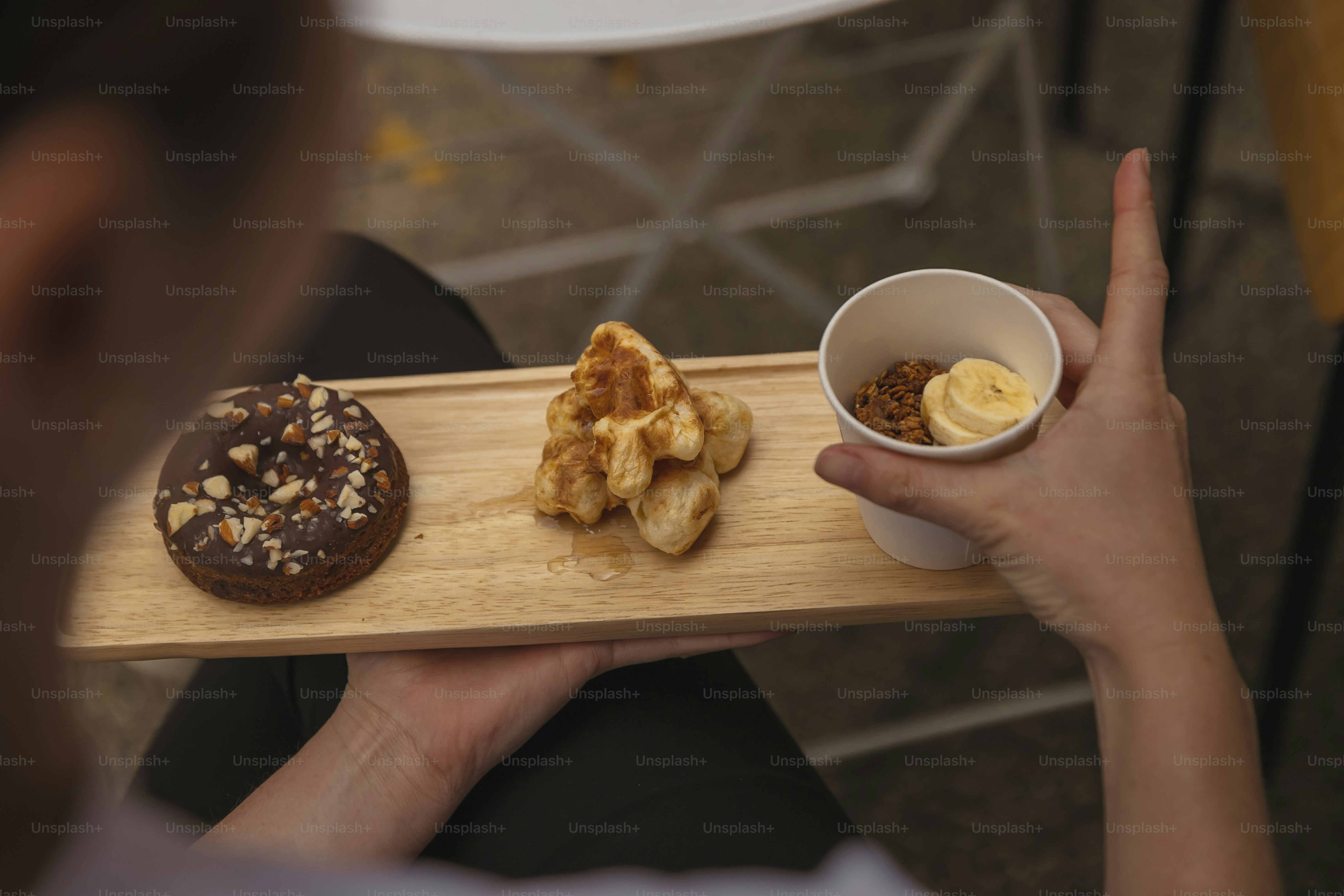 a person is holding a wooden tray with food on it