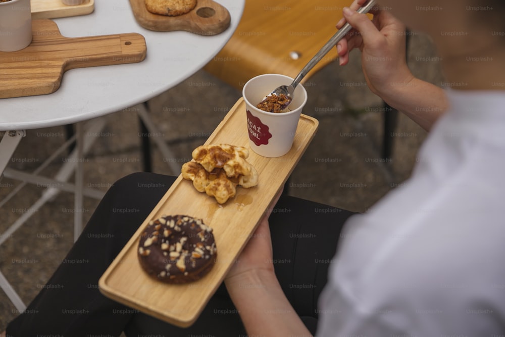 a person sitting at a table with a tray of food