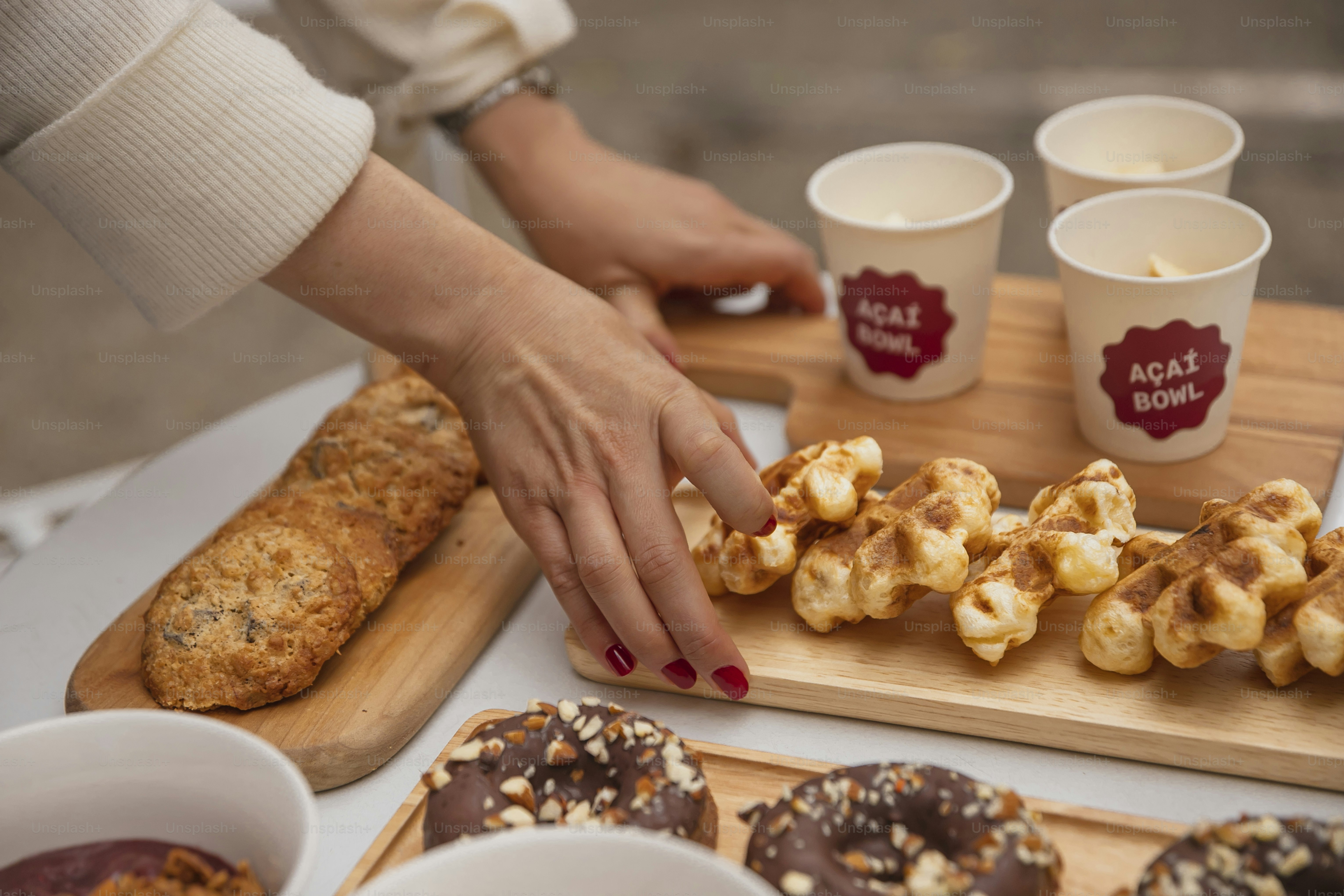 a person reaching for some food on a table