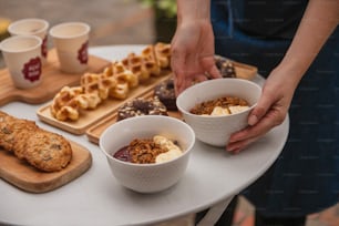 a table topped with bowls of food and cups of coffee