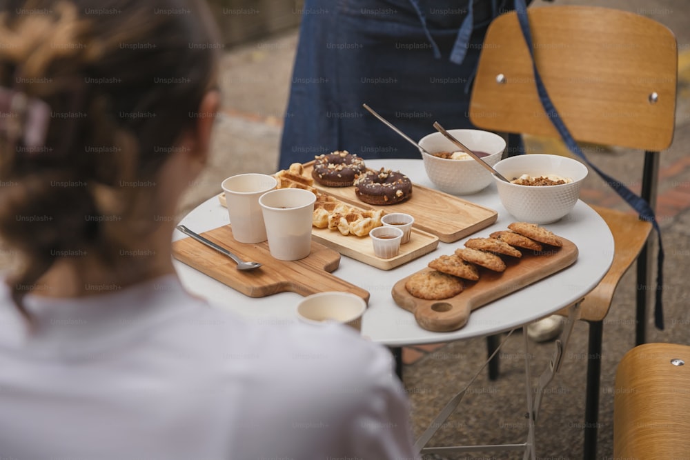 a woman sitting at a table with a tray of food