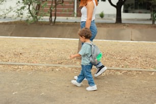 a woman and a child walking in a park