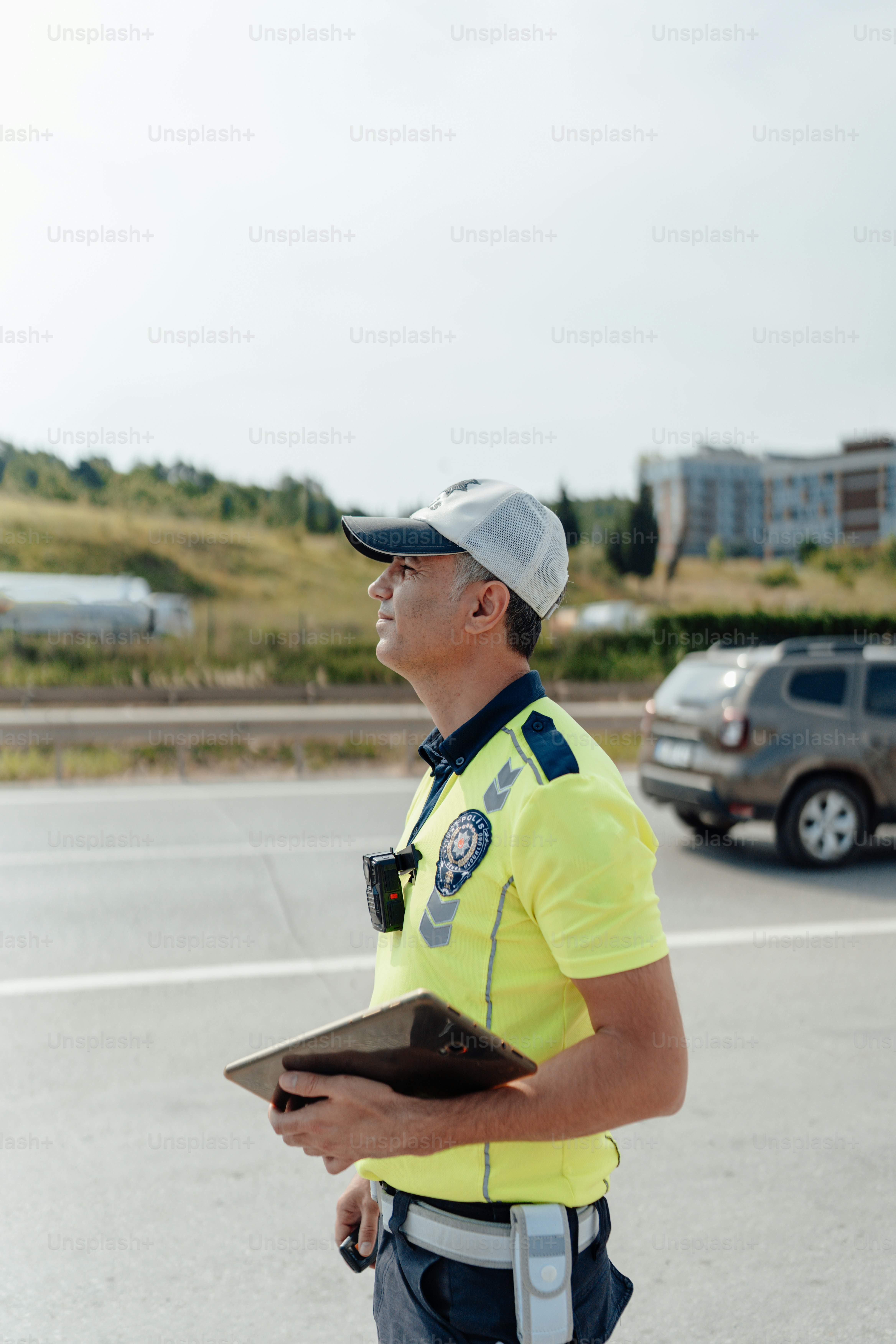 a man in a yellow shirt is standing in the street