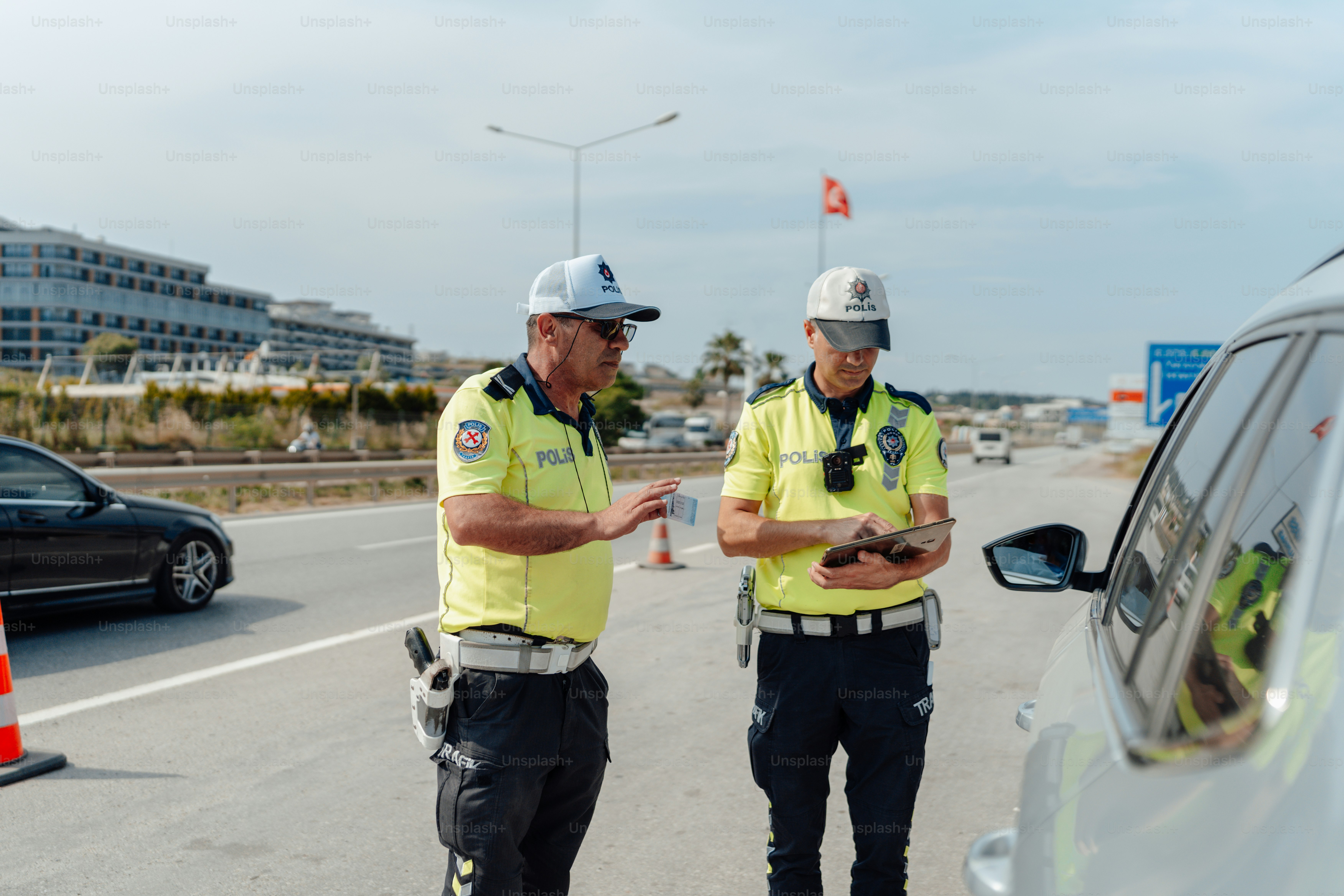 a couple of men standing next to a car