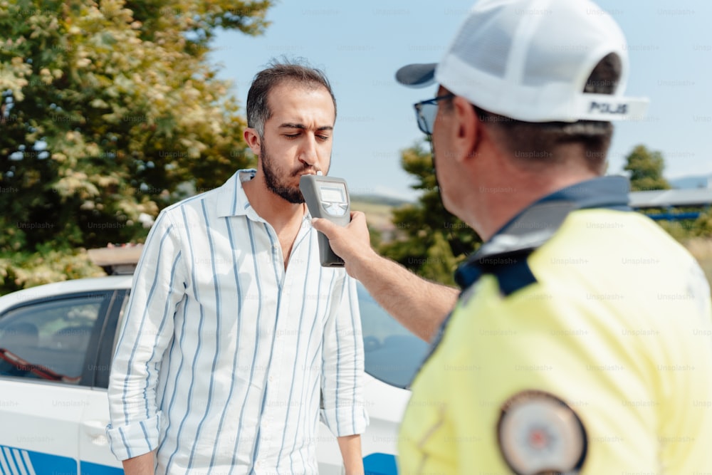 a police officer talking to a man in a hard hat