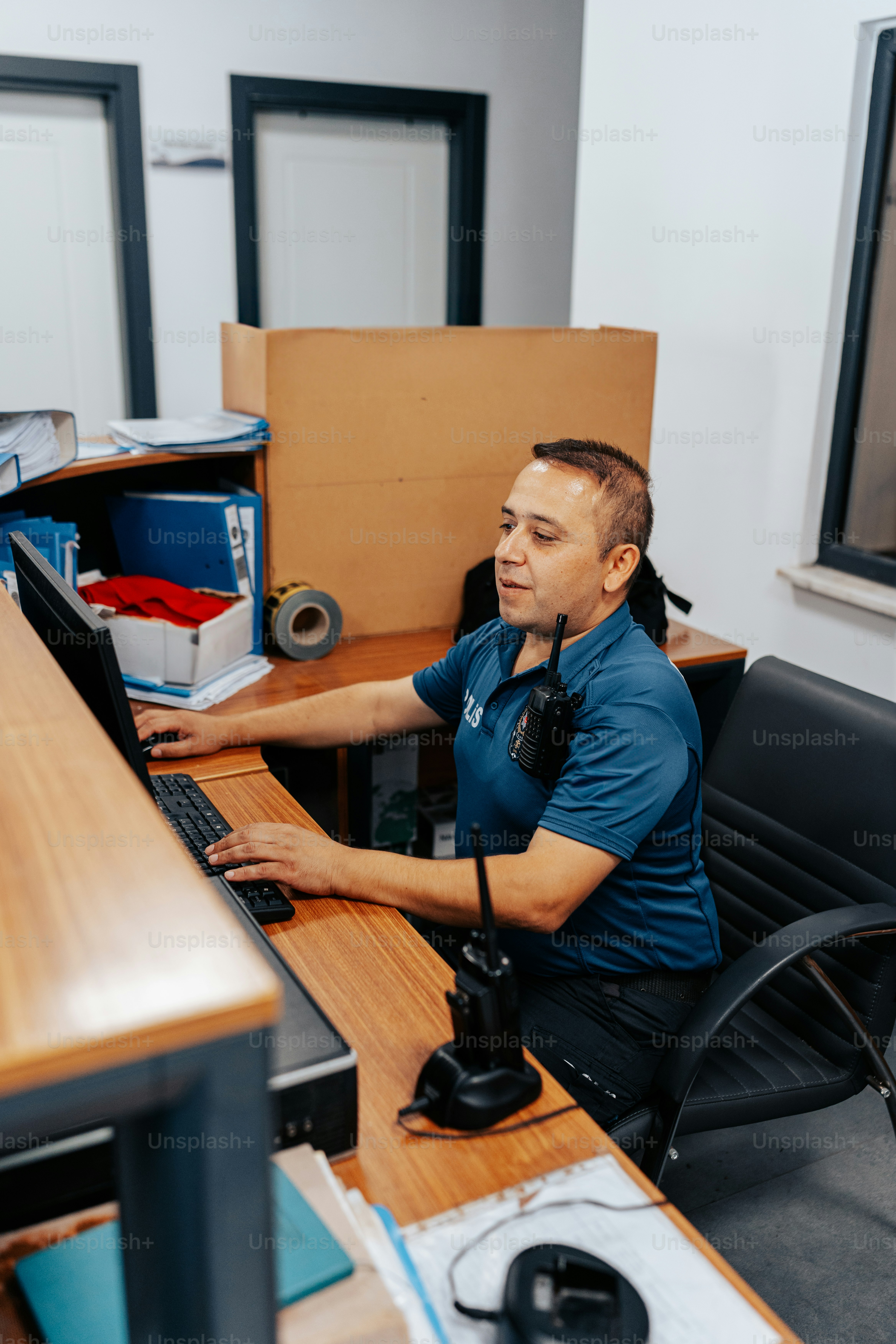 a man sitting at a desk using a computer