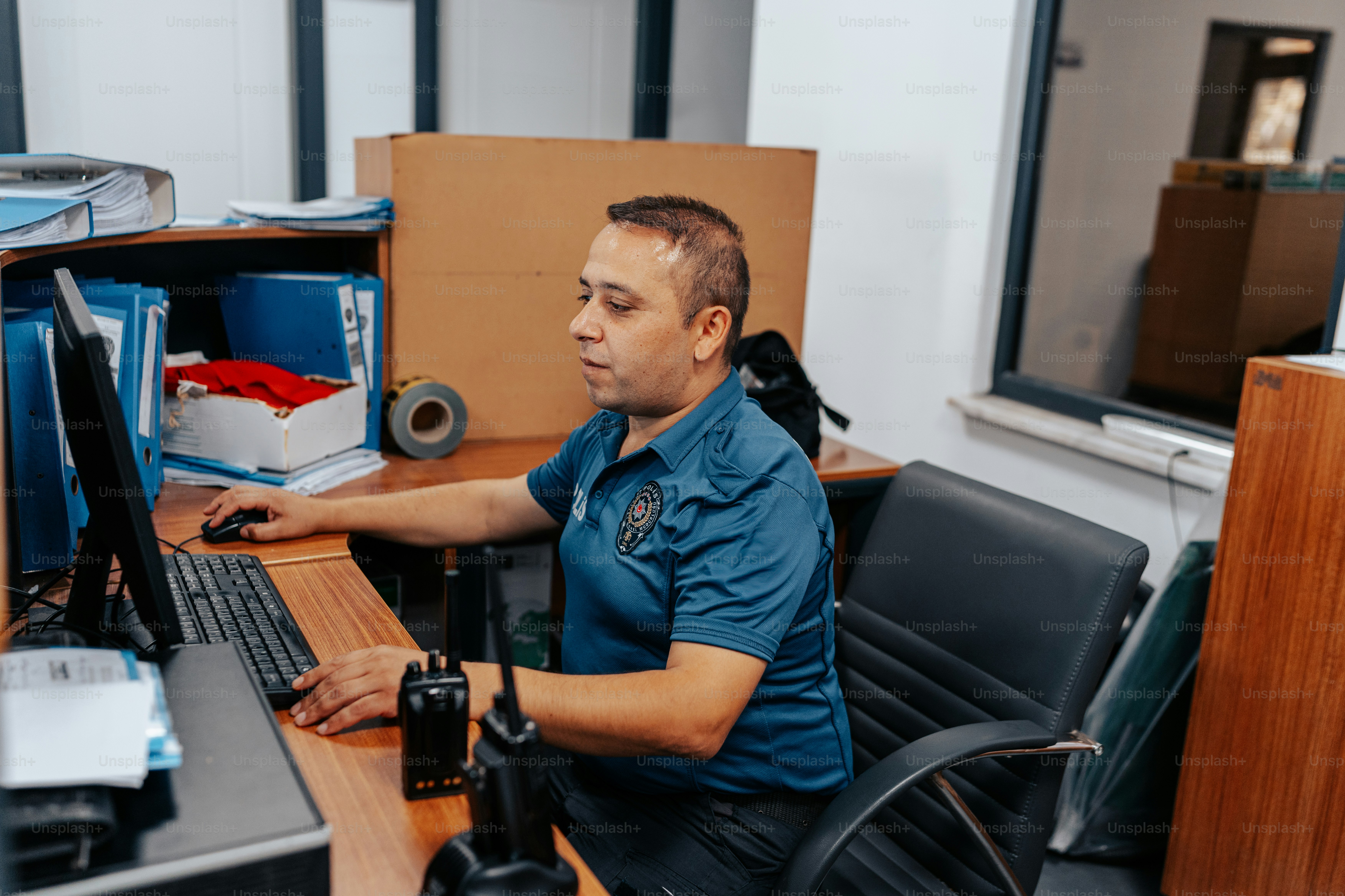 a man sitting at a desk using a computer