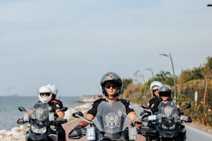 a group of people riding motorcycles down a road