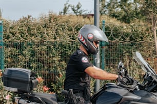 a man in a helmet is sitting on a motorcycle
