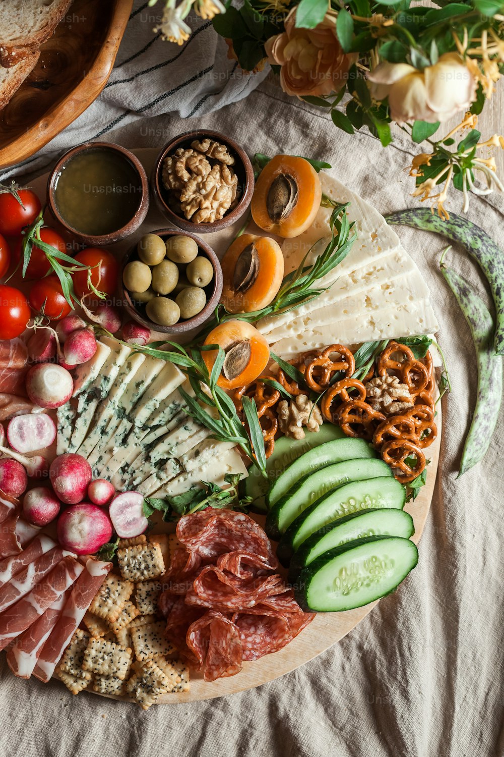 a platter of meats, cheeses, and vegetables