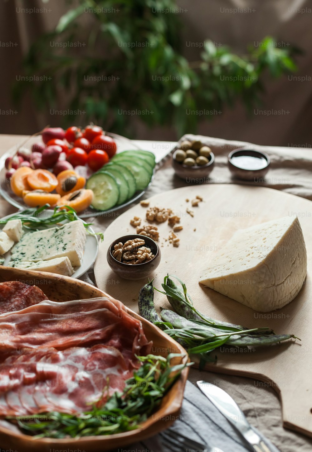 a variety of meats and cheeses on a table