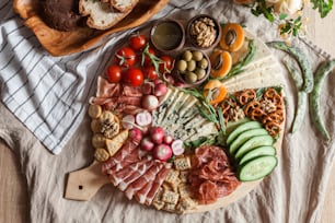 a platter of meats, cheeses, and vegetables