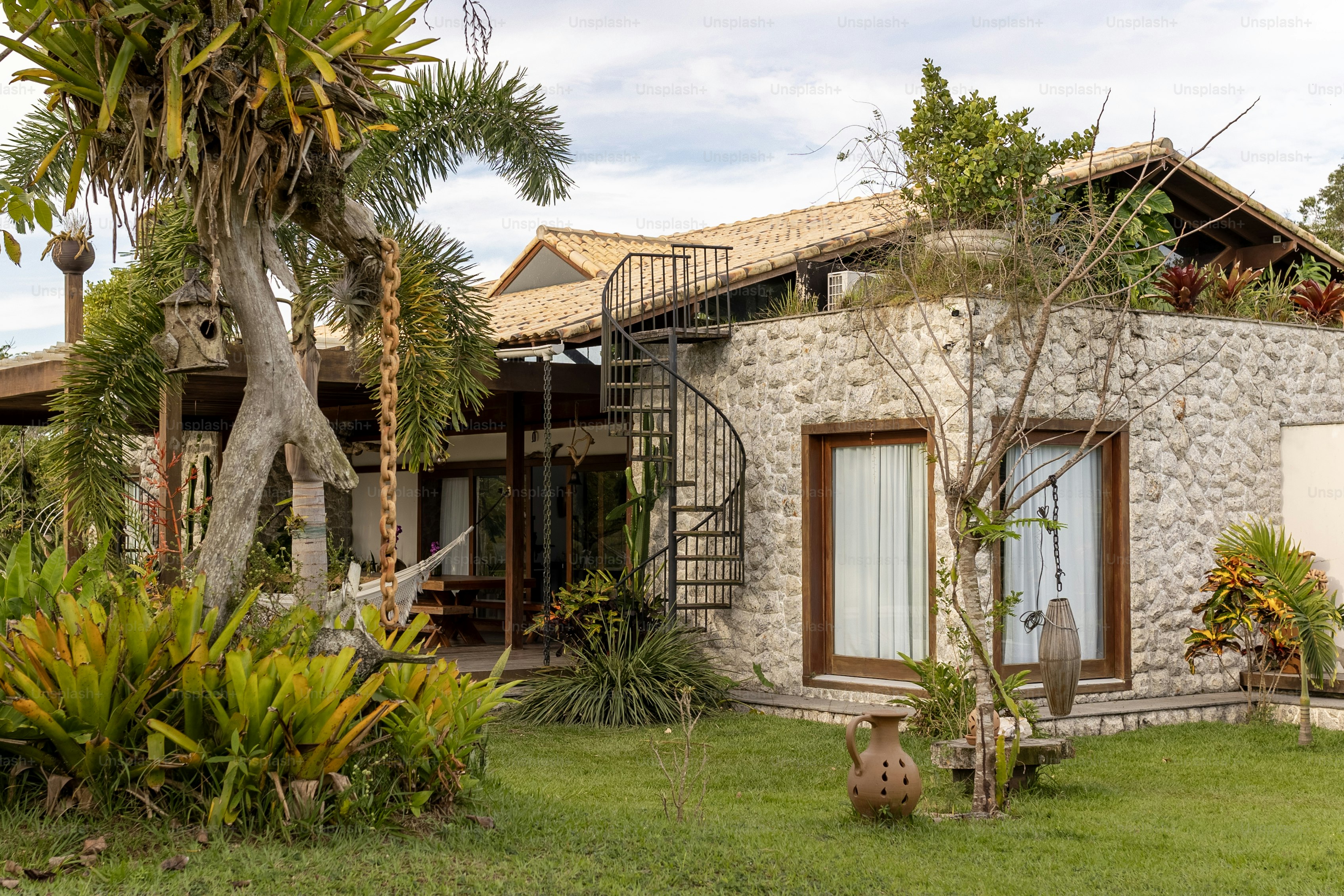 a stone house with a spiral staircase leading up to it