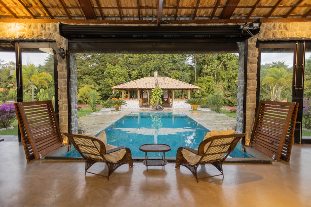 two chairs sitting in front of a swimming pool