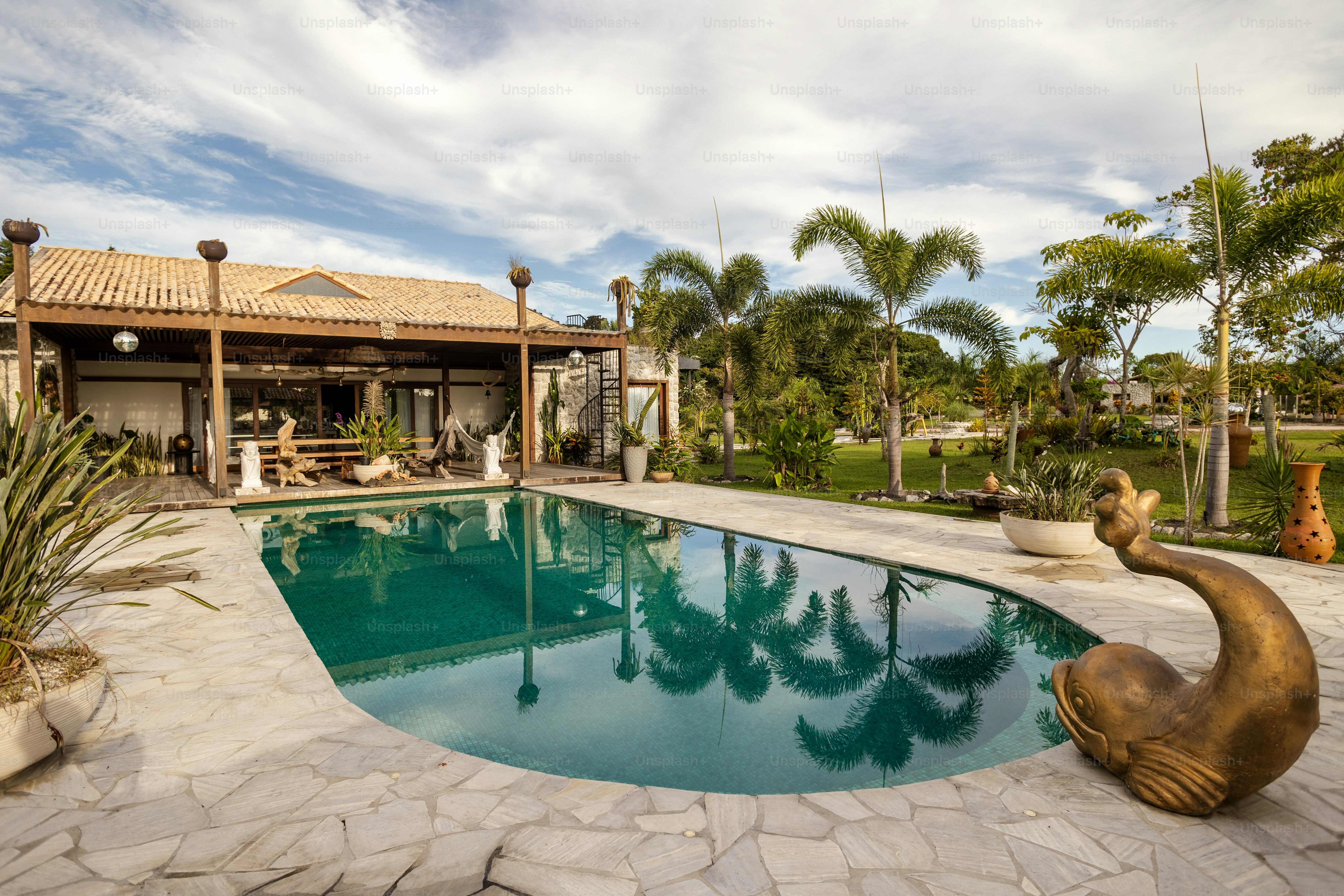 a large swimming pool with a statue of a duck next to it