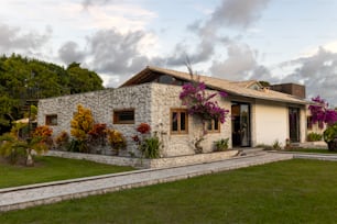 a house with flowers growing on the side of it