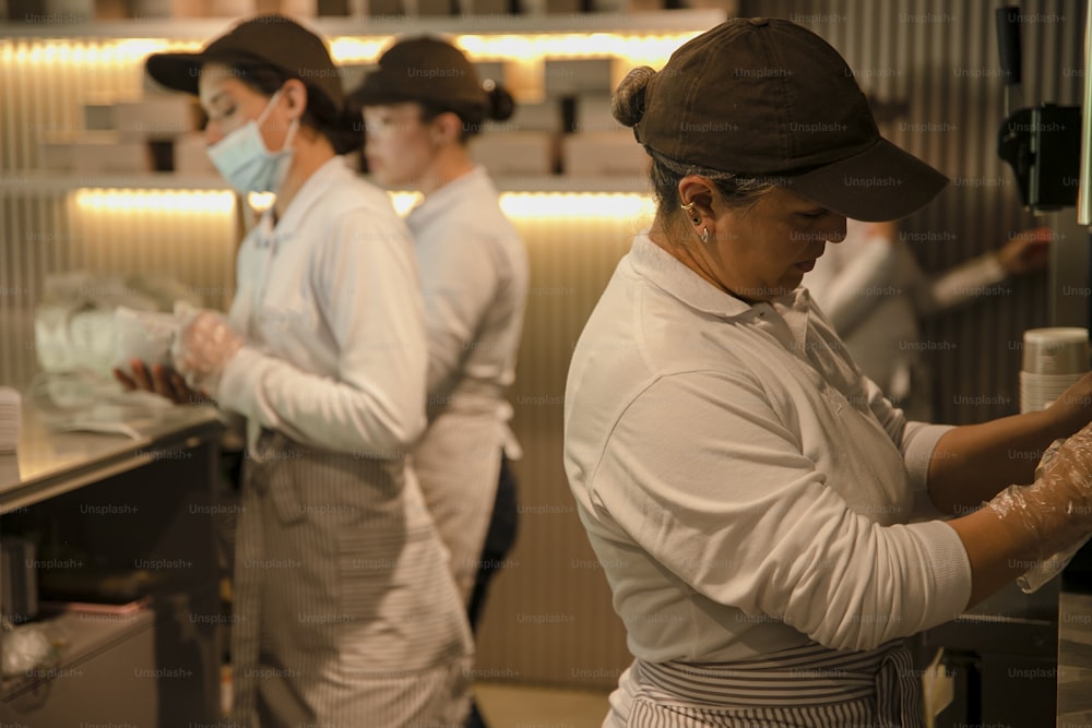 a group of people working in a kitchen