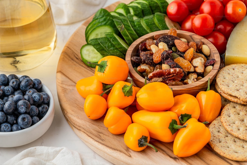 a wooden plate topped with fruits and vegetables