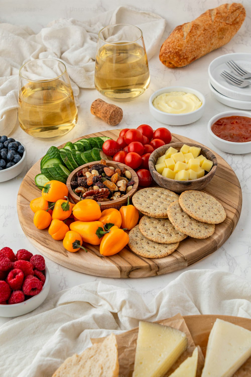 a platter of cheese, crackers, fruit, and crackers