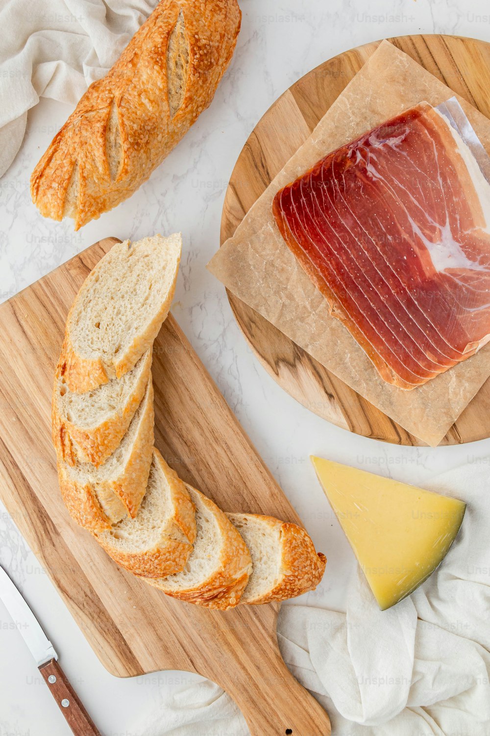 a wooden cutting board topped with slices of bread