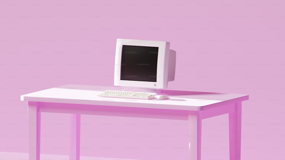 ein Computermonitor, der auf einem Schreibtisch sitzt