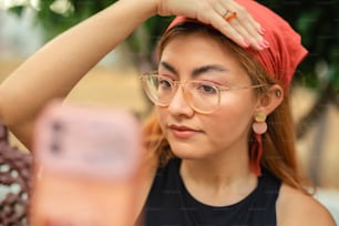a woman wearing glasses and a red bandana