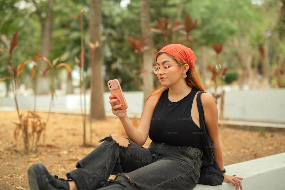 a woman sitting on a bench holding a cell phone