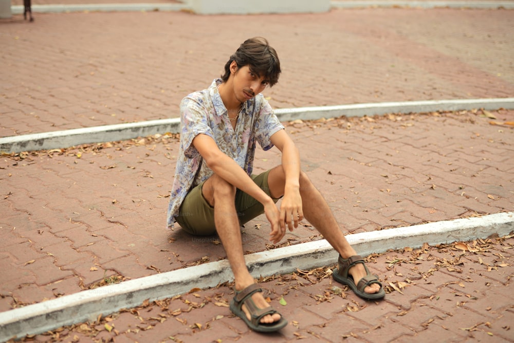 a man sitting on the ground with his foot on the ground