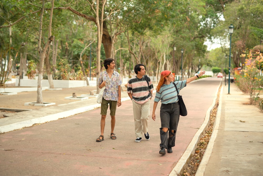 a group of people walking down a sidewalk