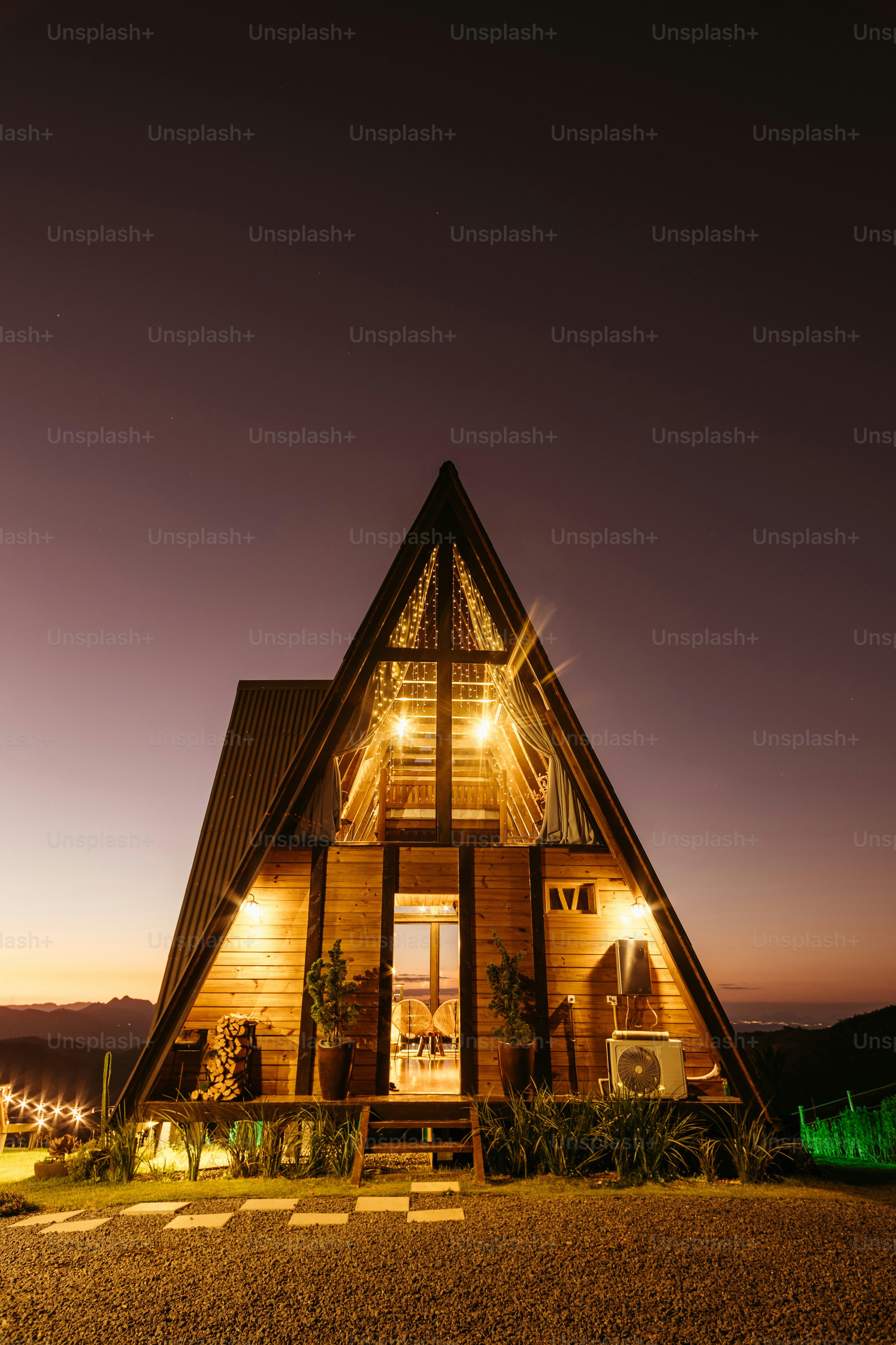 A wooden house lit up at night on a hill photo – Luxury Image on Unsplash