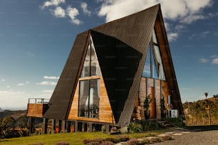 a large triangular shaped building with windows on top of it