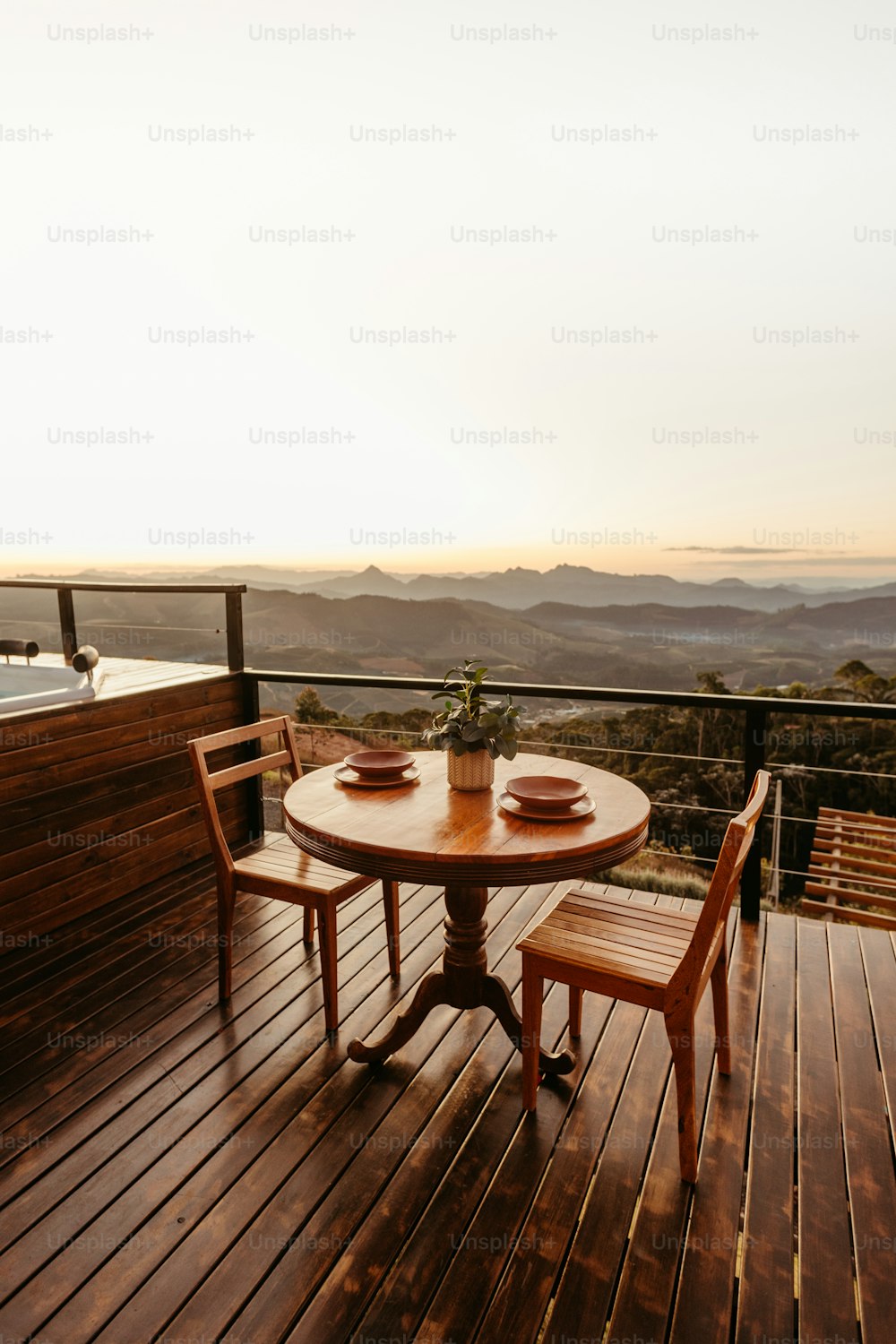 a table and two chairs on a wooden deck