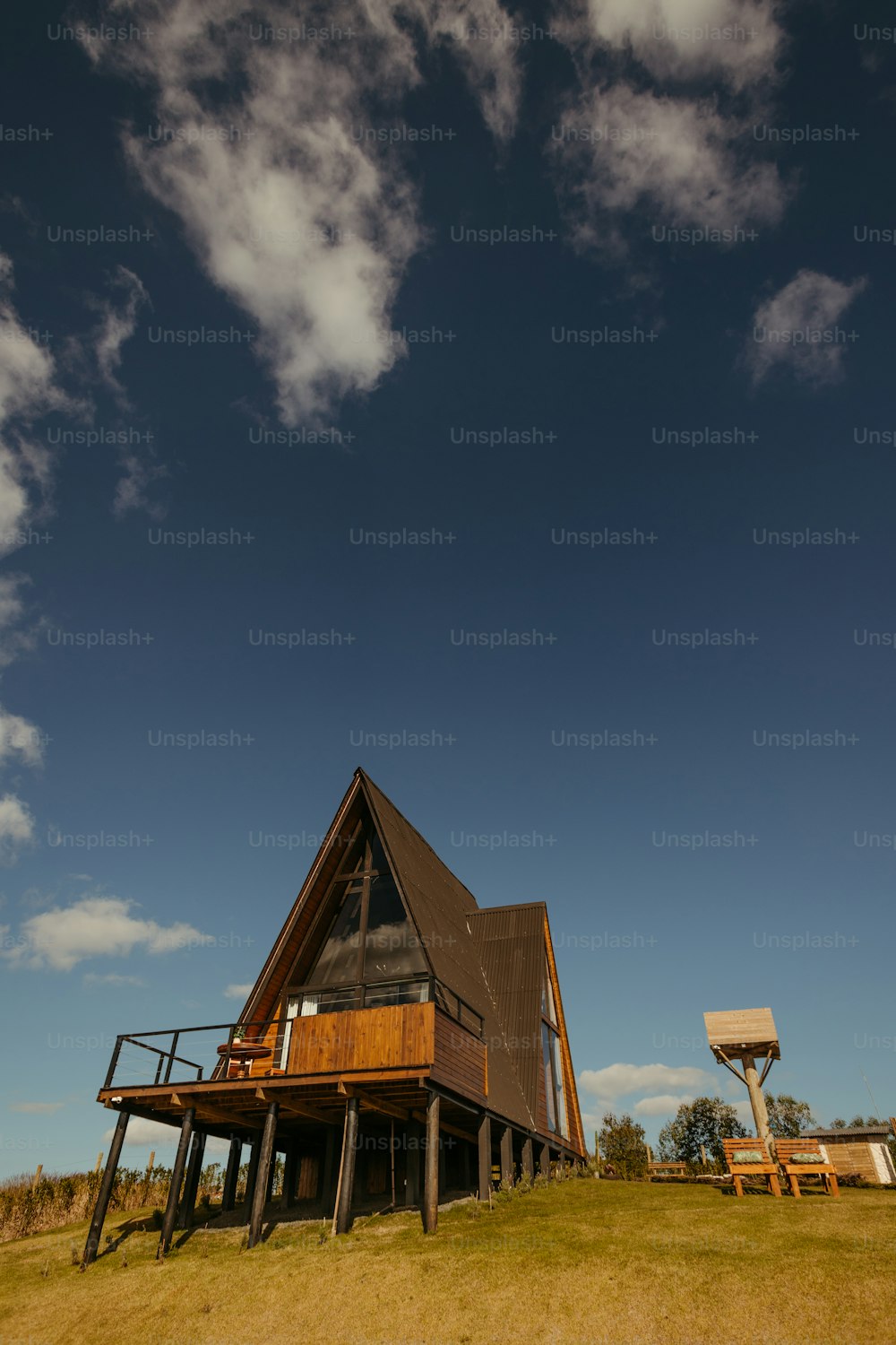 a house sitting on top of a lush green field