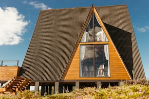 a large wooden house with a sloping roof