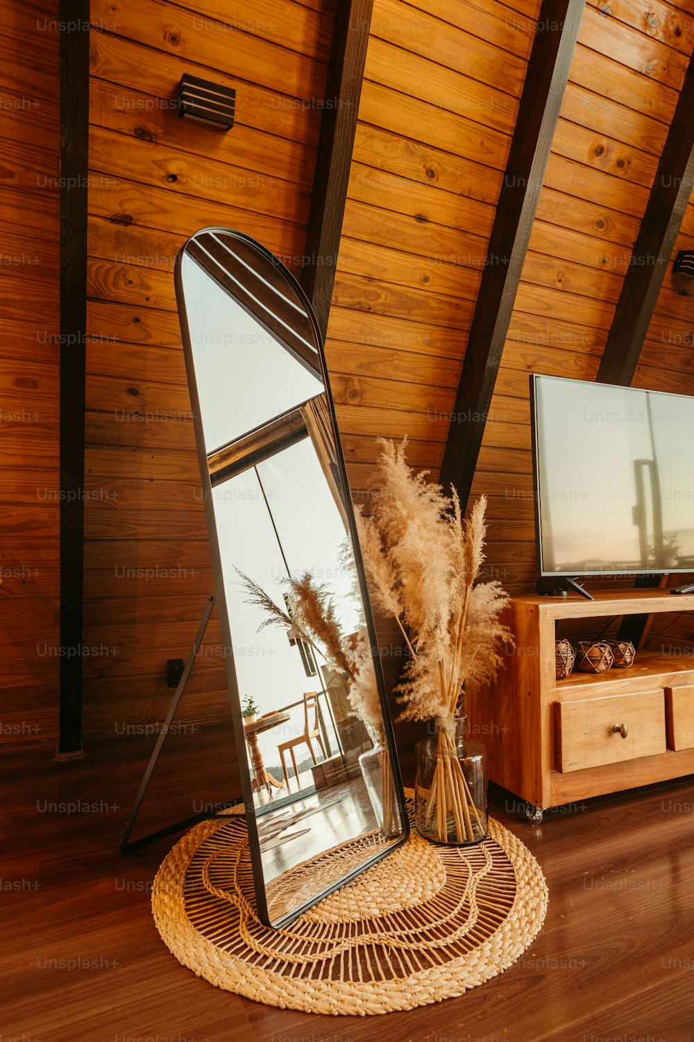 a large mirror sitting on top of a wooden floor