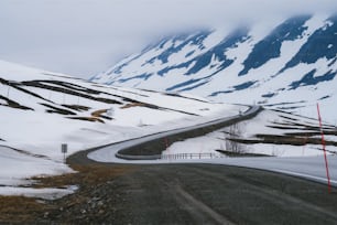 Eine lange, kurvenreiche Straße in den schneebedeckten Bergen
