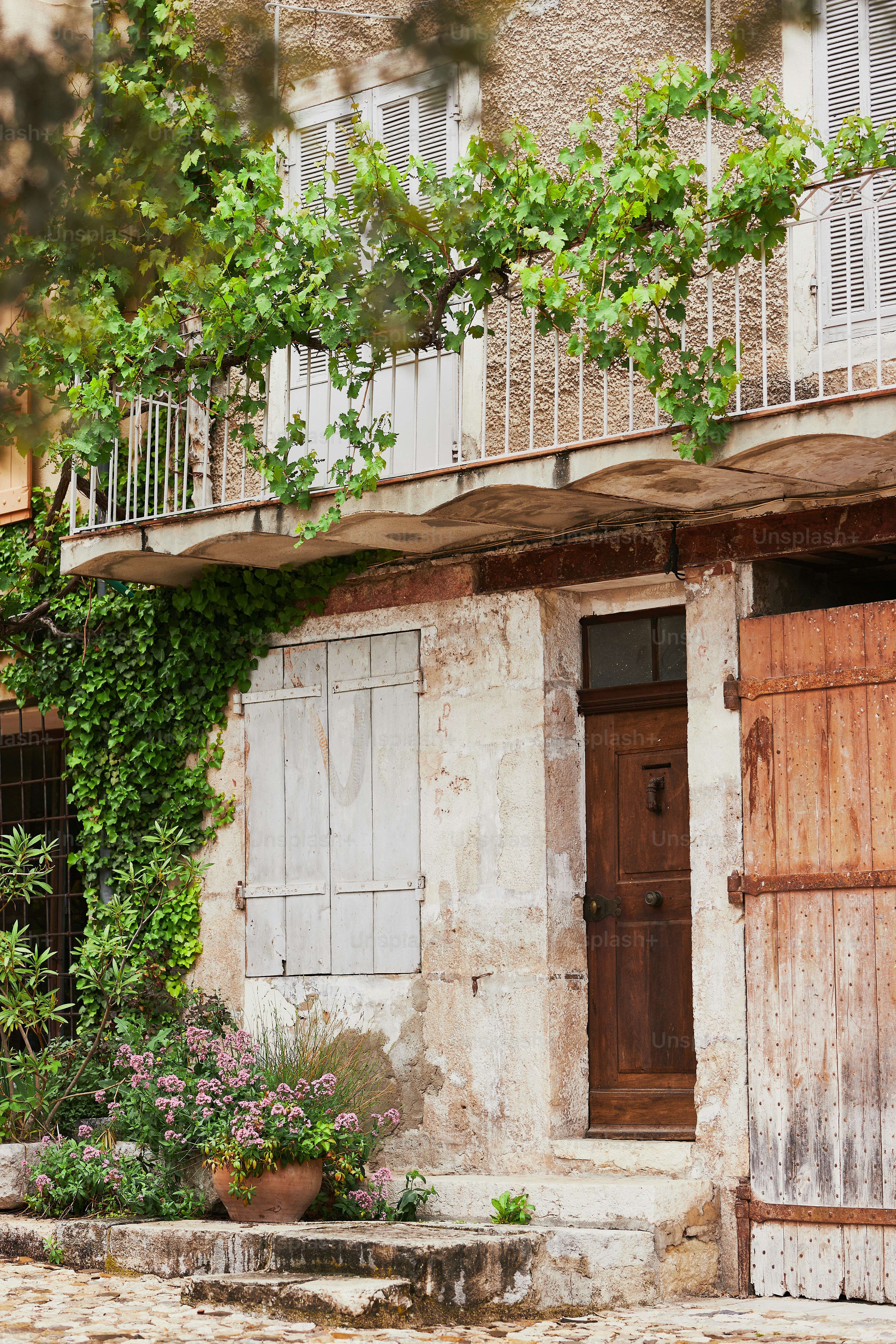 an old building with a wooden door and a balcony