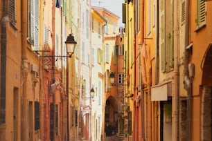 a narrow city street lined with tall buildings