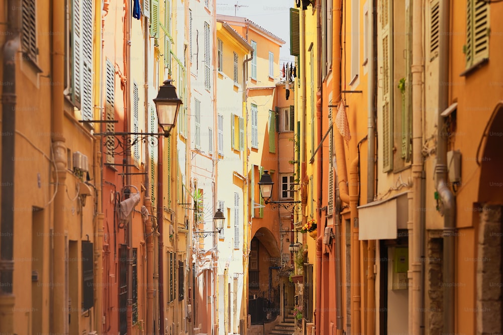 a narrow city street lined with tall buildings