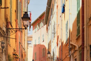 a narrow street with a lamp post and buildings