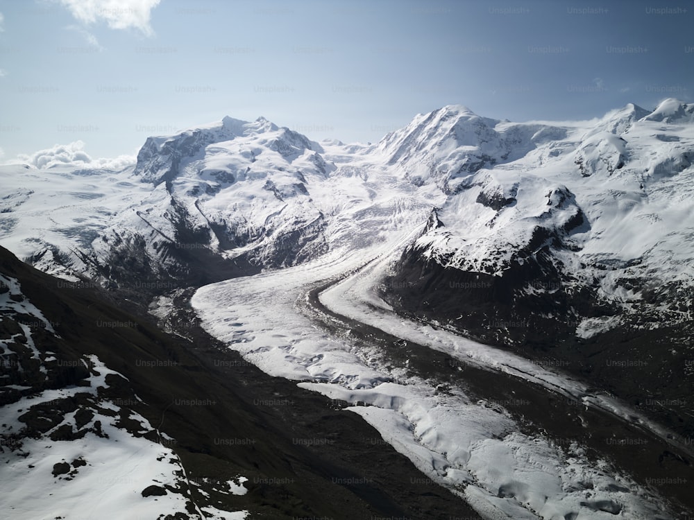 an aerial view of a snow covered mountain range