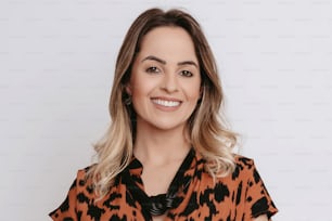 a woman in an orange and black shirt smiling