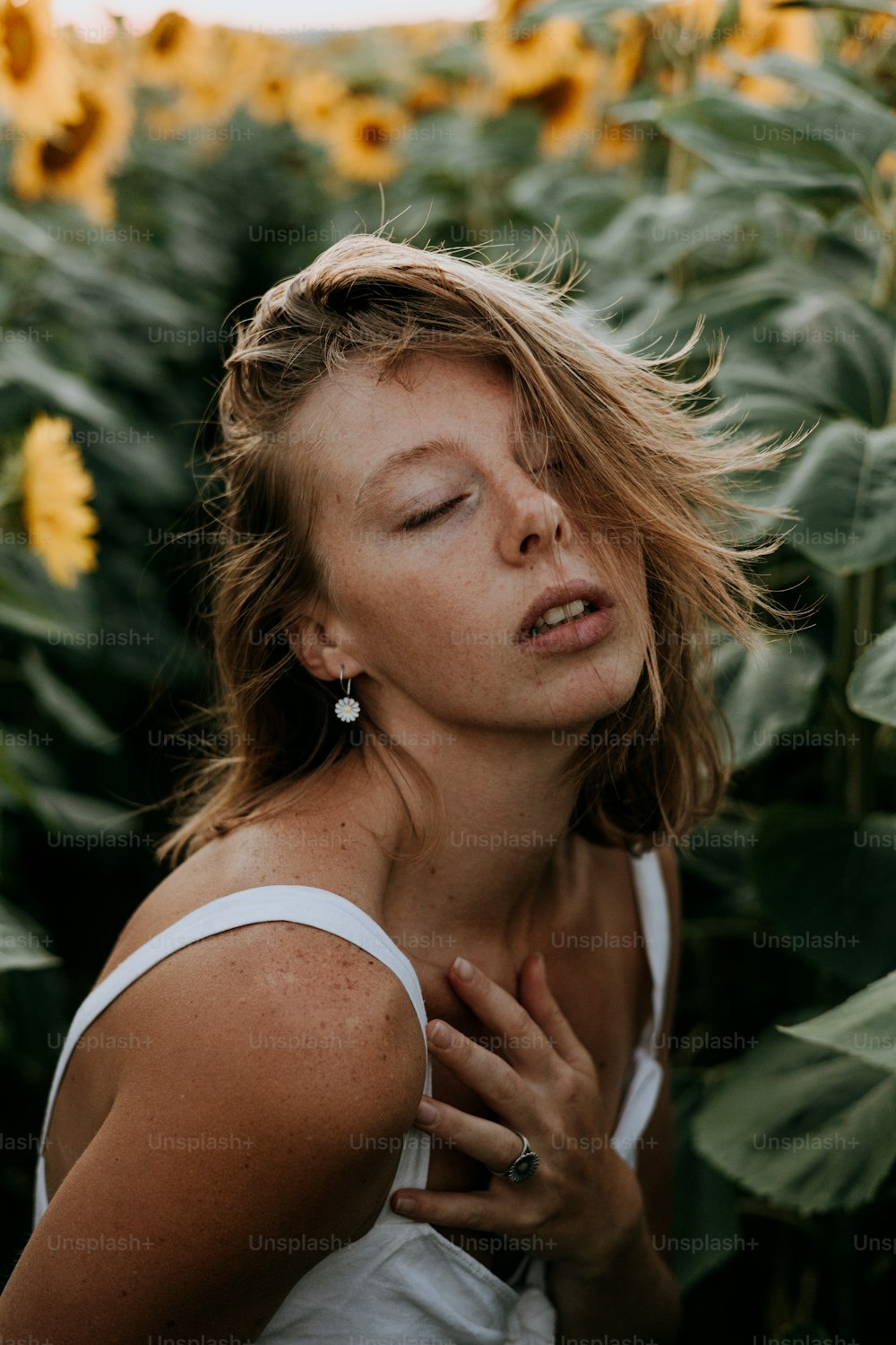 a woman standing in a field of sunflowers